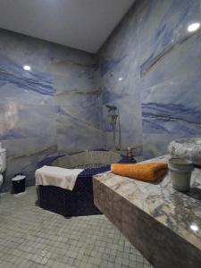 a bathroom with a shower and a bath tub at Riad Zinoun & Spa 11 Rooms in Marrakesh +185 photos