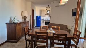 a kitchen and dining room with a table and chairs at Relax e vista Lago Trasimeno vicino Montepulciano in Sant'Albino +13 photos