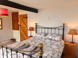 a bedroom with a bed and a wooden door at Stunning Jurassic 3 bed with views over Lyme Bay in Lyme Regis