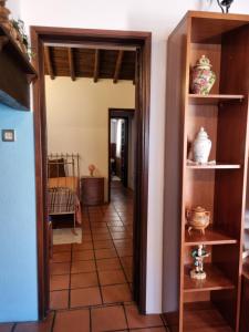 a hallway in a house with a door open at Casa Avó Bia in Reguengos de Monsaraz