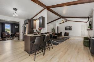 a kitchen and living room with a counter and chairs at Bourbon Trail-Speakeasy&Golf&Spa&Dog Friendly in Frankfort