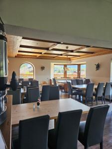 a dining room with tables and chairs at Sonnenburg Hotel in Ehrwald