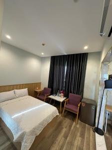 a bedroom with a bed and a table and chairs at 118 Orchid in Phú Quốc +22 photos