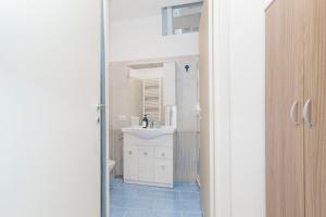 a bathroom with a white sink and a mirror at Molino Lounge Express 20' da Milano e Malpensa in Saronno