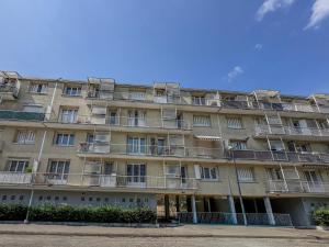 an apartment building with balconies on the side of it at Le Perrin - Parc Paul Mistral - Stade des Alpes in Grenoble