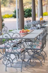 a picnic table with a bowl of fruit on it at Elegant & Exclusive Boutique GuestHouse in Gaborone