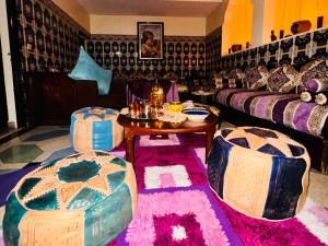 a living room with couches and a table and chairs at Tigme Bleue Wave in Tama ou Ennza