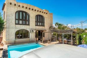 a home with a swimming pool in front of a building at Casa Matilde Vista Mare con Piscina by Wonderful Italy in Carrozziere – Fonte Ciane