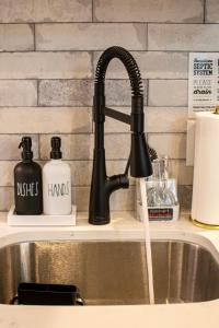a kitchen sink with a black kitchen faucet at Tiny Home - Grill, Near East Fork in Mentone