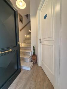 a hallway with a white door and stairs at Casa Gaeta in Gaeta +10 photos