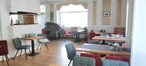 a restaurant with tables and chairs in a room at Hotel Zur Fähre in Boppard