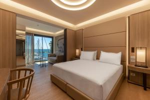 a bedroom with a bed and a desk and a couch at Porto Lotti Suite Hotel in La Spezia