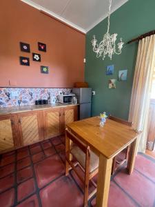 a kitchen with a wooden table and a dining room at Bokmakierie Studio in Montagu