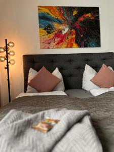 a bedroom with two beds and a painting on the wall at Premium Apartment Wohlfühl-Oase mit Pool und Sauna in Sankt Englmar