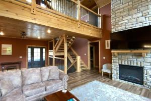 a living room with a couch and a fireplace at The Sundrop - Pool Table, Arcade Games, Outdoor Hot Tub, + Resort Access in Chalet Village