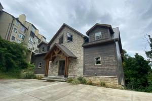 a house with a gambrel roof at The Sundrop - Pool Table, Arcade Games, Outdoor Hot Tub, + Resort Access in Chalet Village