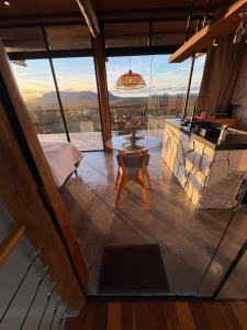 a room with a table and a large window at Chalé Angico in Sao Jorge