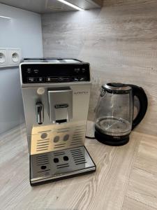 a coffee maker is sitting next to a coffee pot at Apartmán Lima in Piešťany