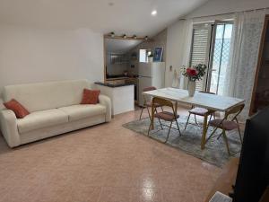 a living room with a couch and a table at Umberto I Apartament in Naples