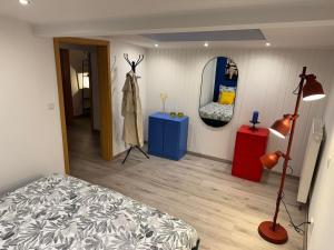 a bedroom with a bed and a mirror at Kleines Wiesel in Gladbeck +6 photos
