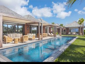 a swimming pool in the backyard of a house at Villa Tycia in Saint Barthelemy