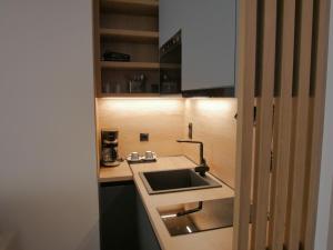 a small kitchen with a sink and a counter at JKB Panoramic Suites in Athens +42 photos