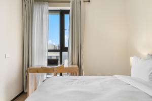 a bedroom with a bed and a desk with a window at GTC Elephant 2 bed by YourHost Nairobi in Nairobi