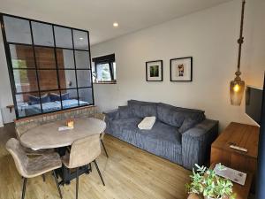 a living room with a couch and a table at Hey Spreewald Ferienapartments in Lübben