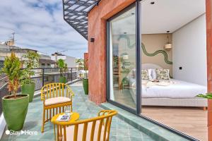 a balcony with a bedroom and a bed on it at Stayhere Casablanca - Maarif - Elite Residence in Casablanca