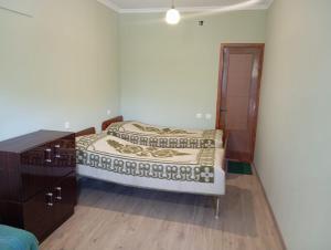 a bedroom with two beds and a dresser at Vahan Guest House in Tatʼev