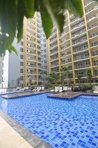 a large swimming pool in front of some tall buildings at Kuya Awens Staycation in Manila