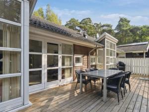 a patio with a table and chairs on a deck at Holiday Home Dorit - 600m from the sea by Interhome in Hasle