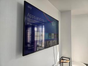 a flat screen tv hanging on a wall at One bedroom flat in Barking