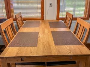 a wooden table with four chairs and a wooden table at Holiday Home Karhunvartijan linna a1 by Interhome in Ruka