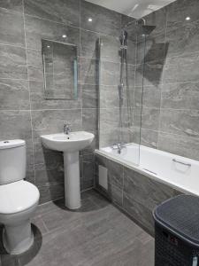 a bathroom with a toilet and a sink and a shower at One bedroom flat in Barking