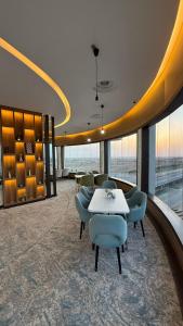 a room with a table and chairs in a building at Artama Hotel in Unayzah +43 photos