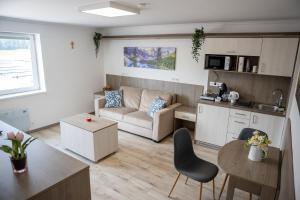 a living room and kitchen with a couch and a table at HunGasthaus 05&06 in Mariazell