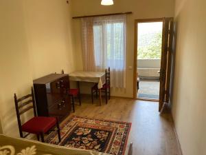 a room with a table and chairs and a dining room at Vahan Guest House in Tatʼev
