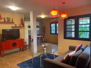 a living room with a couch and a tv at Old City Hidden Gem Villa in Chiang Mai