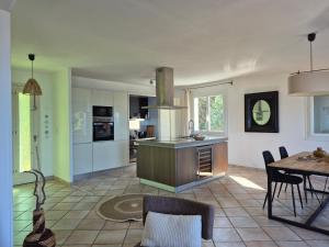 a kitchen and dining room with a table and chairs at Cap en Corse in Farinole