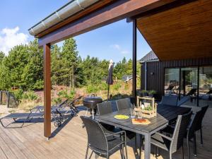 a patio with a table and chairs on a deck at Holiday Home Heidi - 1km from the sea by Interhome in Mølby