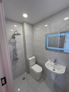 a bathroom with a toilet and a sink at Stylish House in Kutaisi