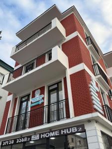 a red and white building with a home hub at Stylish House in Kutaisi