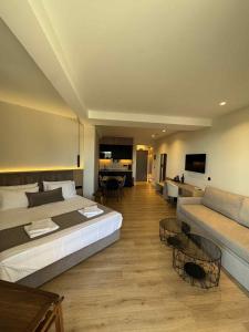 a large bedroom with a large bed and a couch at JKB Panoramic Suites in Athens