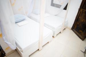 a room with two bunk beds in a room at WHITE HOUSE STAR Hotel in Malindi