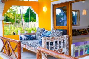 a living room with a couch and a window at Craft House - An Artistic Oasis in Watamu