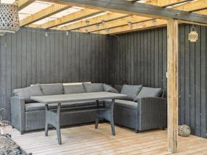 a patio with a picnic table and two chairs at Holiday Home Finja - 6km from the sea by Interhome in Horslunde