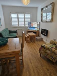 a living room with a couch and a table at By the Beach Perranporth, Truro, cornwall in Perranporth