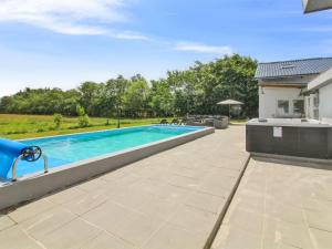 a swimming pool in the backyard of a house at Holiday Home Melin - 7km from the sea by Interhome in Højer