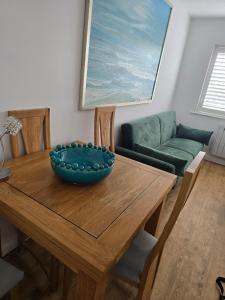 a dining room table with a bowl on top of it at By the Beach Perranporth, Truro, cornwall in Perranporth +7 photos